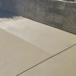 Beautifully landscaped concrete patio area in the backyard of a house in Granada Hills.