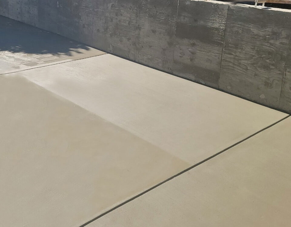 Beautifully landscaped concrete patio area in the backyard of a house in Granada Hills.